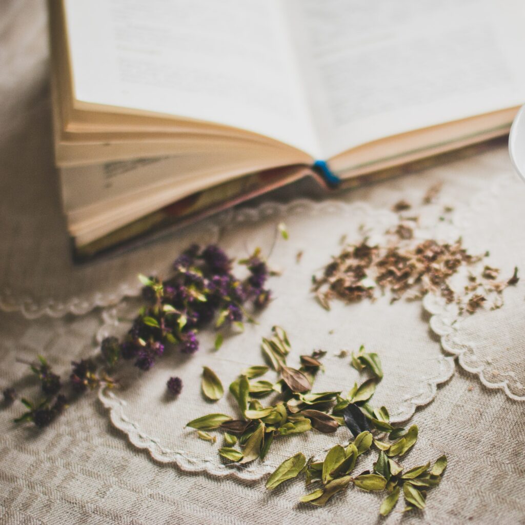 Tea leaves beside an open book.